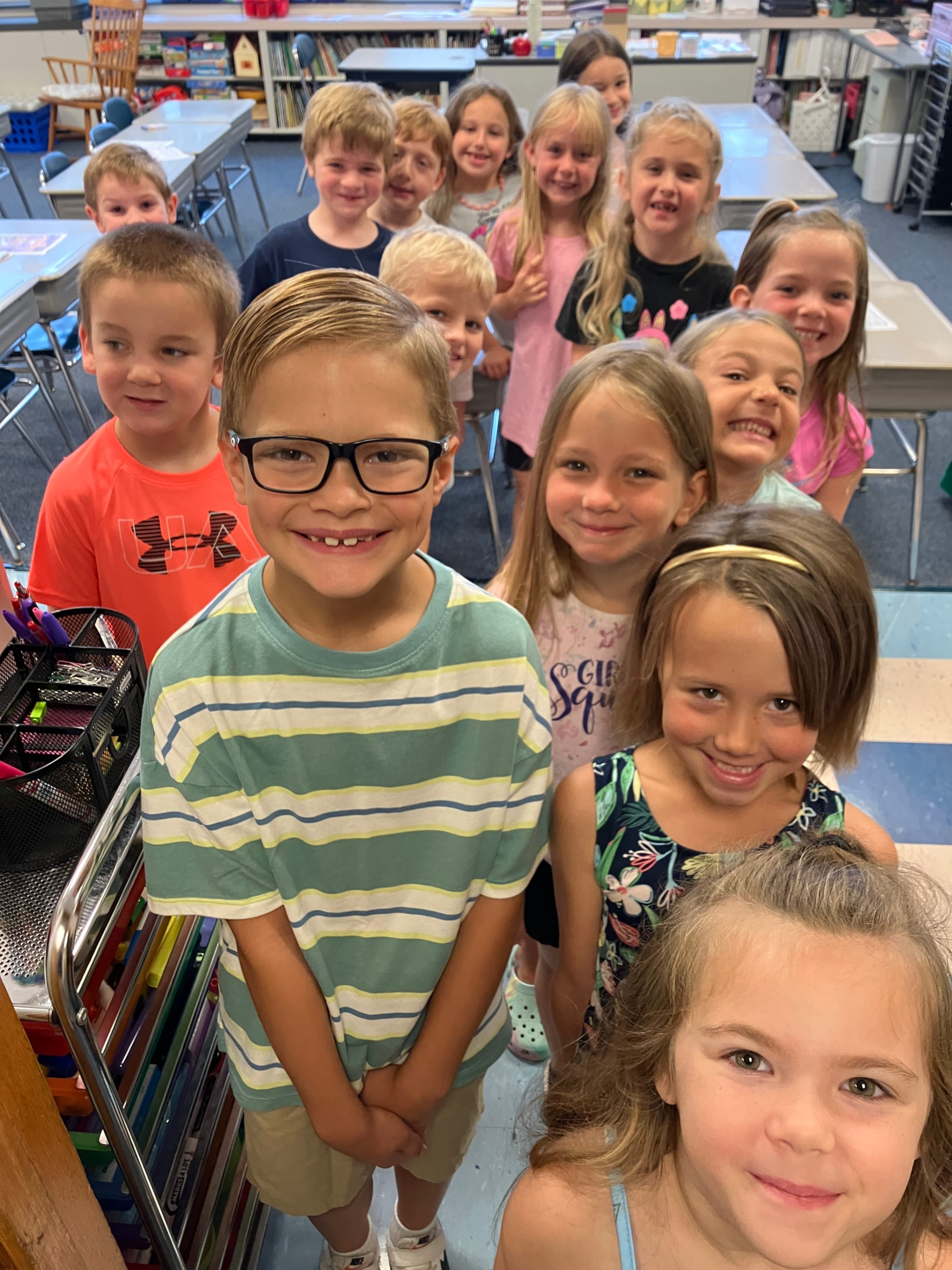 A group of incoming first graders smile for a photo in a classroom at Pinecreek Elementary School.